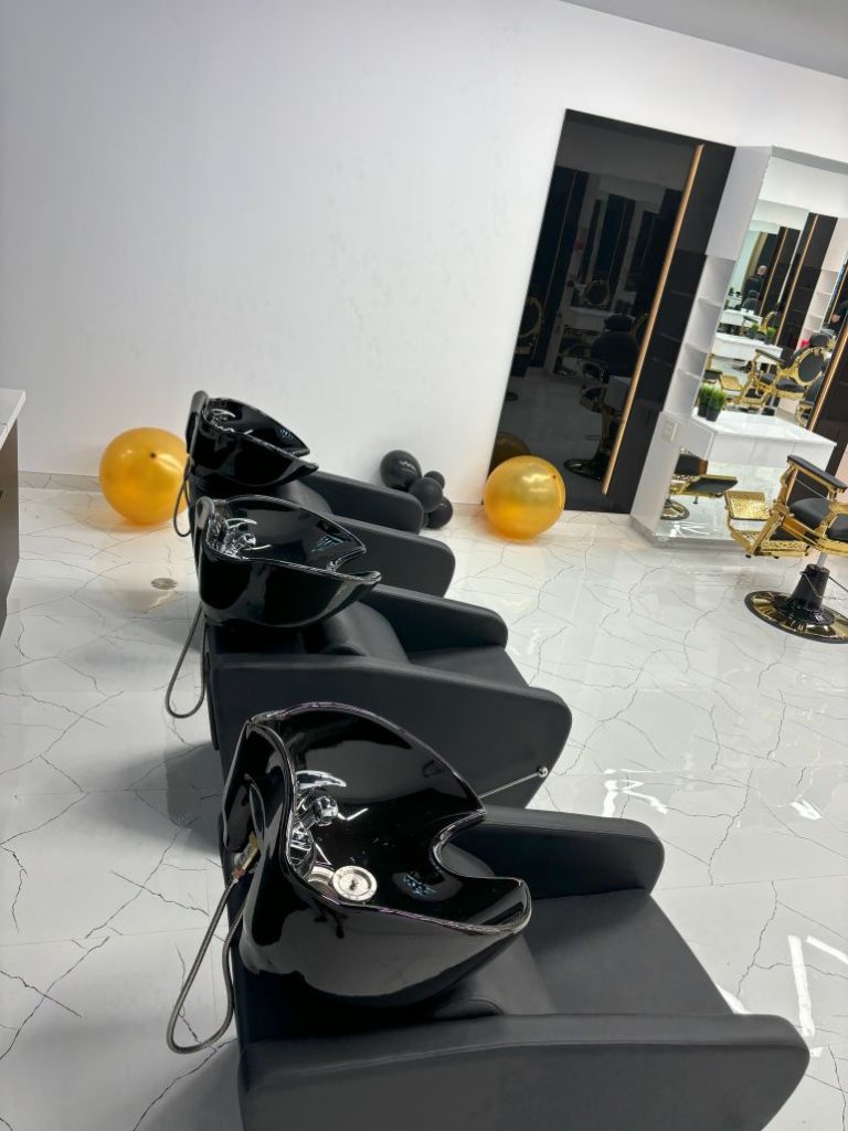 Commercial Plumbing 9 Trio of black wash stations with backflow-protected faucets and wall-mounted spray hoses